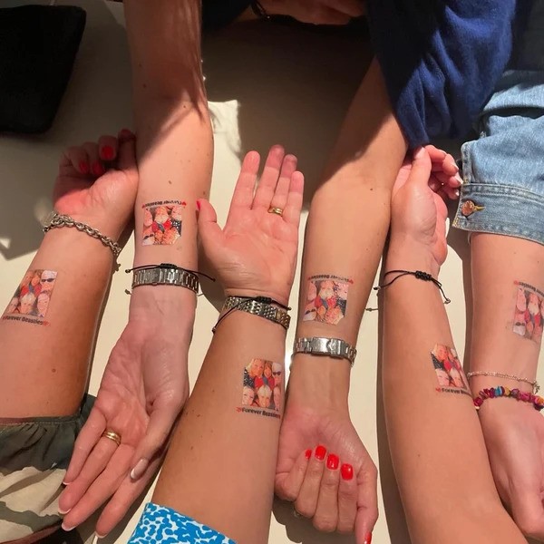 A group of peoples wrists with temporary tattoos