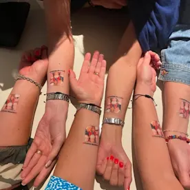 A group of peoples wrists with temporary tattoos