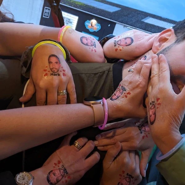A group of peoples wrists with temporary tattoos